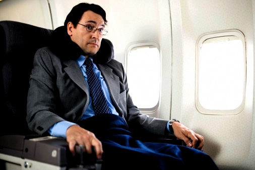 Nervous passenger sitting on airplane